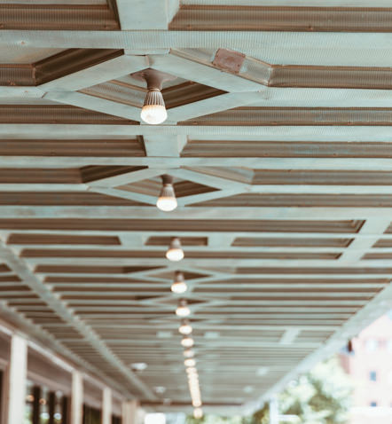 White ceiling with individual lights lined up in a singular row across