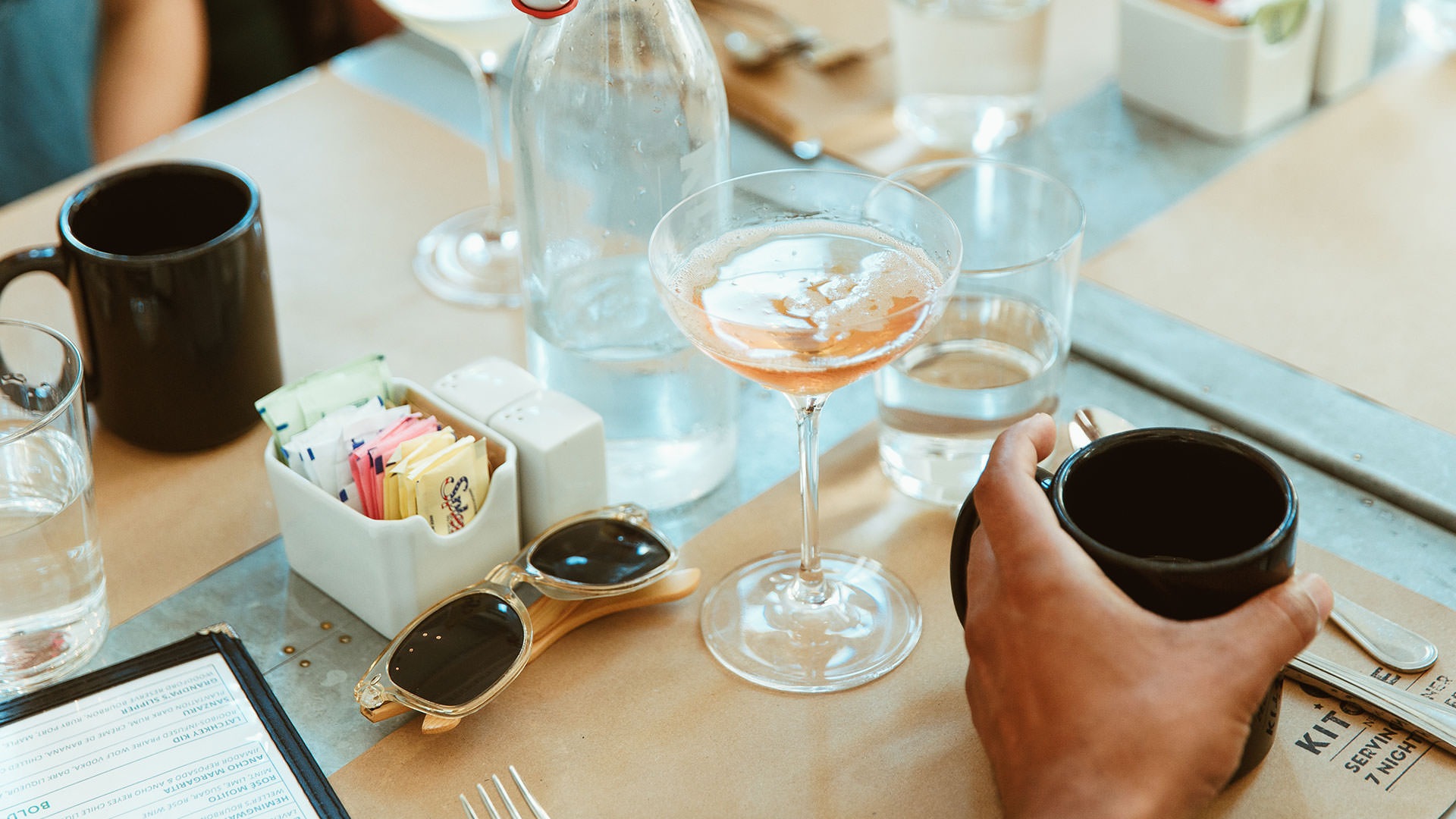 Close up of table with two people enjoying assorted drinks